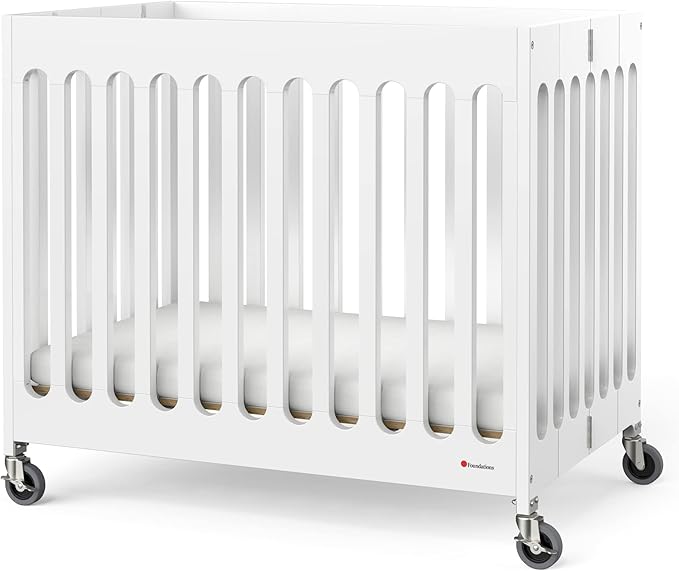 Foundations Boutique Folding Mini Baby Crib - Compact, Portable, Wooden Hotel Crib, Foldable Compact Cribs for Baby & Toddlers - Includes 3" Foam Mattress - White