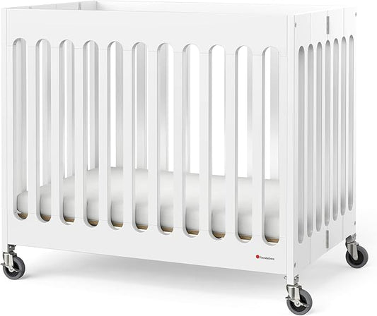 Foundations Boutique Folding Mini Baby Crib - Compact, Portable, Wooden Hotel Crib, Foldable Compact Cribs for Baby & Toddlers - Includes 3" Foam Mattress - White